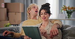 Happy, couple and planning with tablet in new home for online shopping, decor app and decision. Moving, talking and people with tech on sofa for interior design, furniture inspiration and remodeling