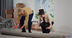Couple, rolling carpet and excited in new home, moving and interior design for flooring with real estate. Man, woman and helping hand with partner, mat and boxes at apartment, relocation and property