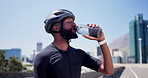 Man, cyclist and drinking water with bottle in city for hydration, workout break or rest. Active, male person or mineral liquid with aqua, beverage or nutrition for exercise or recovery in urban town