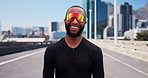 Black man, runner and sunglasses with smile in city for fitness, confidence and outdoor on urban bridge. African person, happy and shades in street for exercise, wellness and cardio training in town