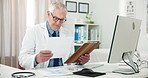 Doctor, man and paperwork with records in office with computer for medical admin or online consulting. Mature person, medicine expert and research in clinic with symptoms, technology and healthcare