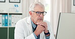Doctor, man or thinking at computer in hospital for treatment planning, review patient info or solution. Healthcare, mature person or tech in practice for clinical decision or medical problem solving