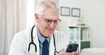 Doctor, happy man and typing in office with phone for social media, check email and text message. Healthcare worker, mature person or smile with tech, online communication or mobile app notification.
