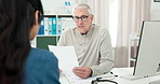 Woman, doctor and talking with document in office for prescription, medical record and referral letter. Mature man, person and diagnosis form of healthcare, treatment progress and discharge paperwork