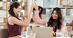 Digital marketing, high five or team in office with laptop, discussion or positive feedback on campaign. Review, women or content analyst in agency with tech, success or approval of brand strategy.