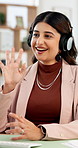 Business woman, wave or video call with headphones for online meeting or webinar in office. Female person, consultant or agent talking with smile for virtual assistance, advice or help in workplace