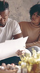 Frustrated couple, documents or finance with stress for cost, over budget or expenses in home. Man, woman or paperwork with debt, invoices or mortgage bills for financial bankruptcy together in house