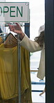 Retail, closed sign and front door with woman in store for fashion merchandiser, signage or storefront notice. Clothing department, end of service and done with person in shop for message and display