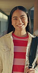 Face, girl and teen in high school with smile, knowledge or scholarship for academic development. Education, gen z and student in hallway with confidence, pride and growth in learning opportunity.