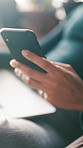 Hand, phone and person in home with communication, contact or social media on mobile app. Technology, networking and cellphone for online texting, chatting or research in living room at apartment.
