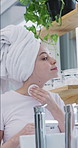 Woman, pad and skincare in bathroom for beauty, wellness and cleaning face with morning routine. Girl, cosmetics and product for dermatology, texture or smile for natural glow with towel at apartment