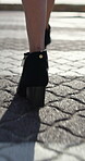 Fashion, walking or legs on street with high heels, trendy shoes or chic style in designer clothing. Outfit, stylish or woman in town with confidence, elegant footwear or boots on city stroll.
