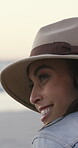 Woman, relax and thinking at beach with smile for summer holiday, travel adventure and wellness. Happy person outdoor, ponder and reflection by ocean with hat for vacation, getaway and weekend break.
