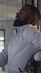 Black man, back pain and stress at office with injury, bad posture and muscle fatigue at startup. African person, spine inflammation and exhausted with burnout, frustrated or ache at creative agency