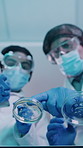 Petri dish, tablet and scientists in laboratory for research, experiment or project for medical development. Tech, goggles and biologists with chemical solution for pharmaceutical study from below.