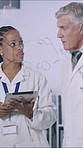 Tablet, discussion and scientists in laboratory for research, project or medical study in collaboration. Teamwork, digital technology and biologists working on pharmaceutical development together.