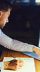 Night, business and man with notebook, laptop and financial advisor with stock market strategy. Evening, investor and person with info journal planning and pc with investment stats and price targets