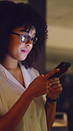 Woman, phone and night at office, texting or glasses with project deadline at startup company. Person, smartphone and scroll on app, networking and check notification for overtime at digital agency