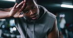 Tired, sweating and face of black man in gym for intense workout, cardio challenge and burnout. Fatigue, bodybuilder and exercise with exhausted person in sports club for fitness and resting