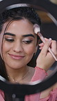 Social media, beauty or girl in house with ring light, live stream or makeup routine in online tutorial. Tech, gen z or influencer with cosmetic brush, product application or blending tips in vlog.