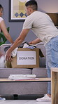 Donation, people or box of clothes in home, sustainability practice or social responsibility in sharing. Packing, generosity or couple with apparel for reuse, philanthropy or charity for timelapse