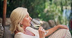Outdoor, mature woman and wine glass for vacation, peace and swirl liquid for flavor improvement. Nature resort, luxury holiday and calm people with alcohol to relax, smell aroma or aeration of drink