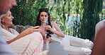 Woman, group, and wine in garden with friends, social gathering or summer event for bonding together. Outdoor, drinks and alcohol with conversation, people and break in backyard for reunion holiday