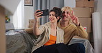 Couple, selfie and happy for moving on sofa, peace sign or excited with boxes in lounge at property. Woman, man and smile with symbol, photography or social media post for relocation with real estate