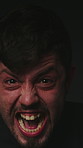 Scream, face and man with flashes for fear, horror and crazy expression. Paranoid, anxiety and isolated male person with nightmare phobia, emotions and shouting reaction on dark studio background