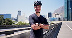Cyclist, arms crossed and face of man in city for triathlon training, fitness and sports. Cardio challenge, wellness and cycling athlete with person outdoor for exercise, health and commitment