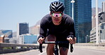 Cyclist, bike and sports with man in city for triathlon training, workout and cardio. Fitness challenge, wellness and cycling athlete with person outdoor for exercise, health and race commitment
