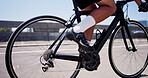 Cyclist, bike and legs with man in city for triathlon training, workout and sports. Fitness challenge, wellness and cycling athlete with person outdoor for exercise, health and race commitment