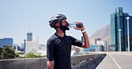 Drinking water, helmet and black man with fitness, outdoor and hydration with practice. African person, relax and cyclist with liquid, bottle or thirsty with aqua, minerals and healthy with nutrition