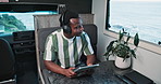 Headphones, choice or black man in caravan with tablet, streaming or listening to song on road trip. Happy, music option or male person in trailer with tech, album or radio subscription on journey.