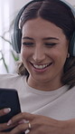 Laugh, headphones and woman on sofa with phone for streaming audio, music and social media. Scroll, home and person on smartphone for radio, funny message and listening to podcast to relax on weekend