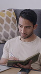 Writing, notes and man with laptop, living room and author with freelance project, research and home. Remote work, writer and person with tech for article on web, reflection or planning with notebook