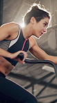 Stationary bike, fitness and health with woman in gym for cardio challenge, sports athlete and workout. Intense training, cycling and exercise with person on equipment in club for energy and ride