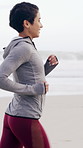 Exercise, health and running with woman on beach in morning for cardio improvement or training. Active, fitness and sport with happy athlete or runner on coast for commitment or workout dedication