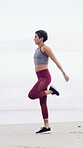 Warm up, runner and fitness with woman on beach for cardio training, health and challenge. Energy, workout and running exercise with person outdoor for sports athlete, wellness and muscle stretching
