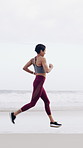 Fitness, running and sport with woman on beach in morning for cardio improvement or training. Active, exercise and health with athlete or runner on coast for commitment or workout dedication