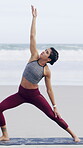 Beach, fitness and woman stretching with yoga mat, balance routine and posture workout for wellness. Reverse warrior pose, flexibility and person with exercise by ocean, muscle mobility and outdoor
