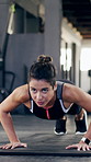 Athlete, woman and push up for fitness in gym for exercise, core strength and balance bodyweight. Female person, floor or intense training for abs, bodybuilding challenge and bicep workout for health