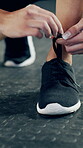 Tying laces, shoes and hands of woman in gym for workout prep, bodybuilder and cardio challenge. Exercise start, sneakers and sports athlete with feet of person in club for training and health