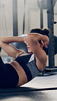 Athlete, woman and sit up for fitness in gym for exercise, core strength and balance bodyweight. Female person, floor and intense training for abs, bodybuilding challenge and bicep workout for health