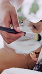 Hands, woman and brush for face mask at spa for skincare, clay facial and cleansing pores. Beautician, person and cosmetic for beauty, natural detox and hydration treatment for skin textures at salon