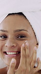 Woman, face and cream for skincare, beauty cosmetics or wellness in bathroom of home. Happy female person, morning routine and smile with lotion, moisturizer product or facial treatment for health