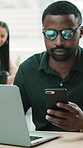 Man, laptop and typing with smartphone at startup, glasses and check notification with coworking at office. Person, phone and computer with project management, contact and report at creative agency