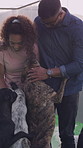Happy, playing and couple with dogs at shelter for adoption, support or volunteering together. Smile, choice and man with woman for rubbing pets for decision on animal foster at kennel on weekend.
