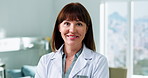 Face, doctor and happy woman in clinic for medical career, about us and confidence with experience. Portrait, mature person or healthcare professional with smile in hospital, pride or wellness in USA