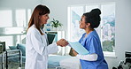 Women, doctor and nurse with handshake for onboarding, meeting or recruiting in clinic. Female people, healthcare workers or shaking hands with introduction for hiring, teamwork or help in hospital
